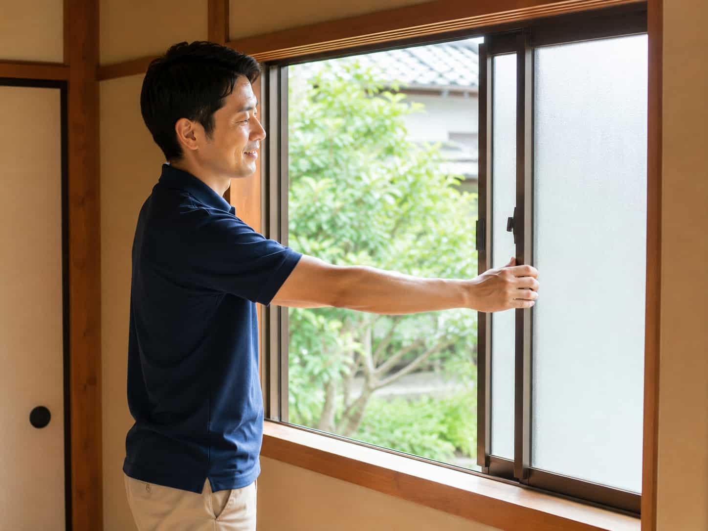 担当スタッフが和室の障子を開けて換気し、水道の通水確認をしている様子